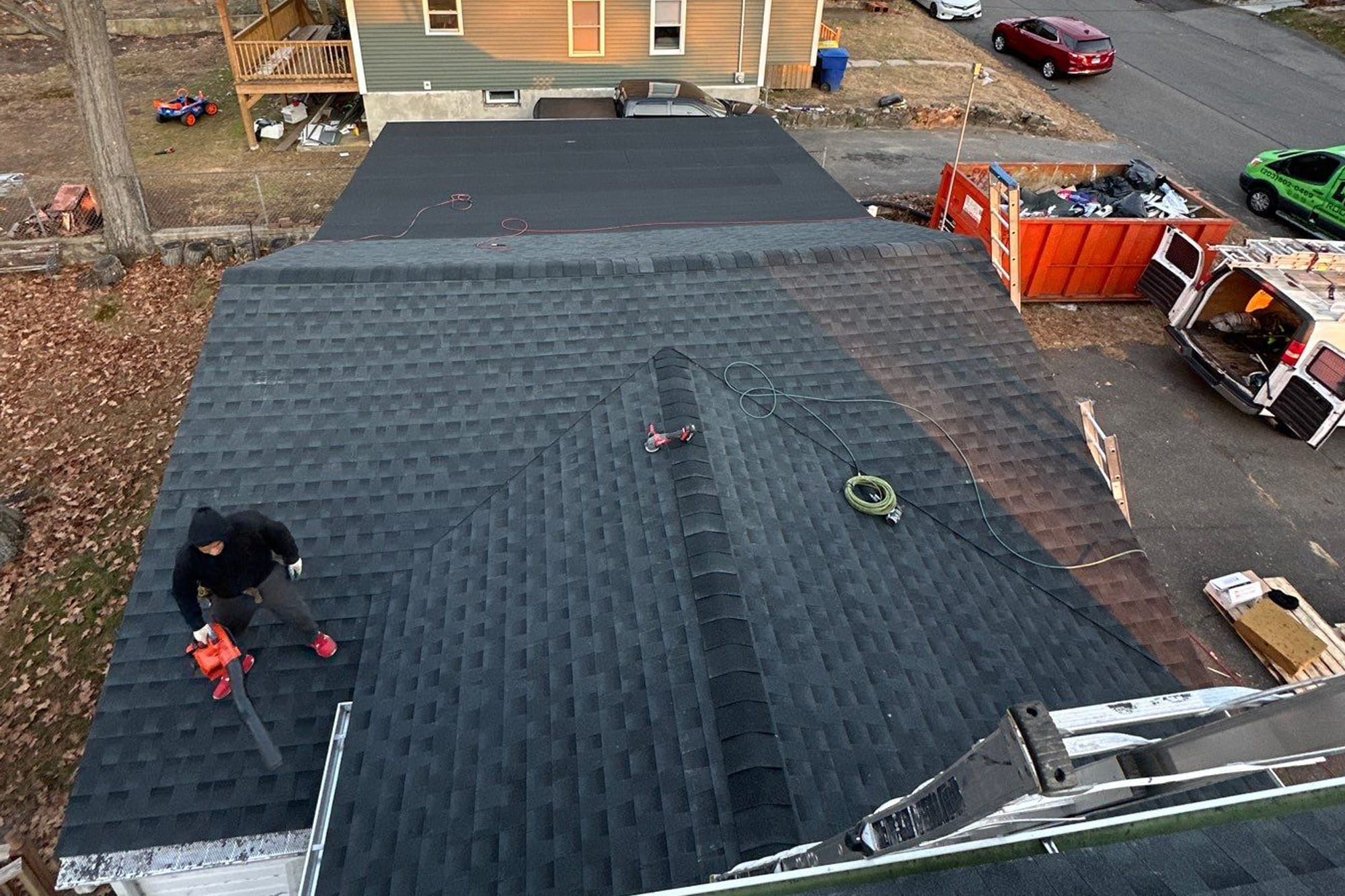 Close-up of roofing tools and safety gear during a roof installation