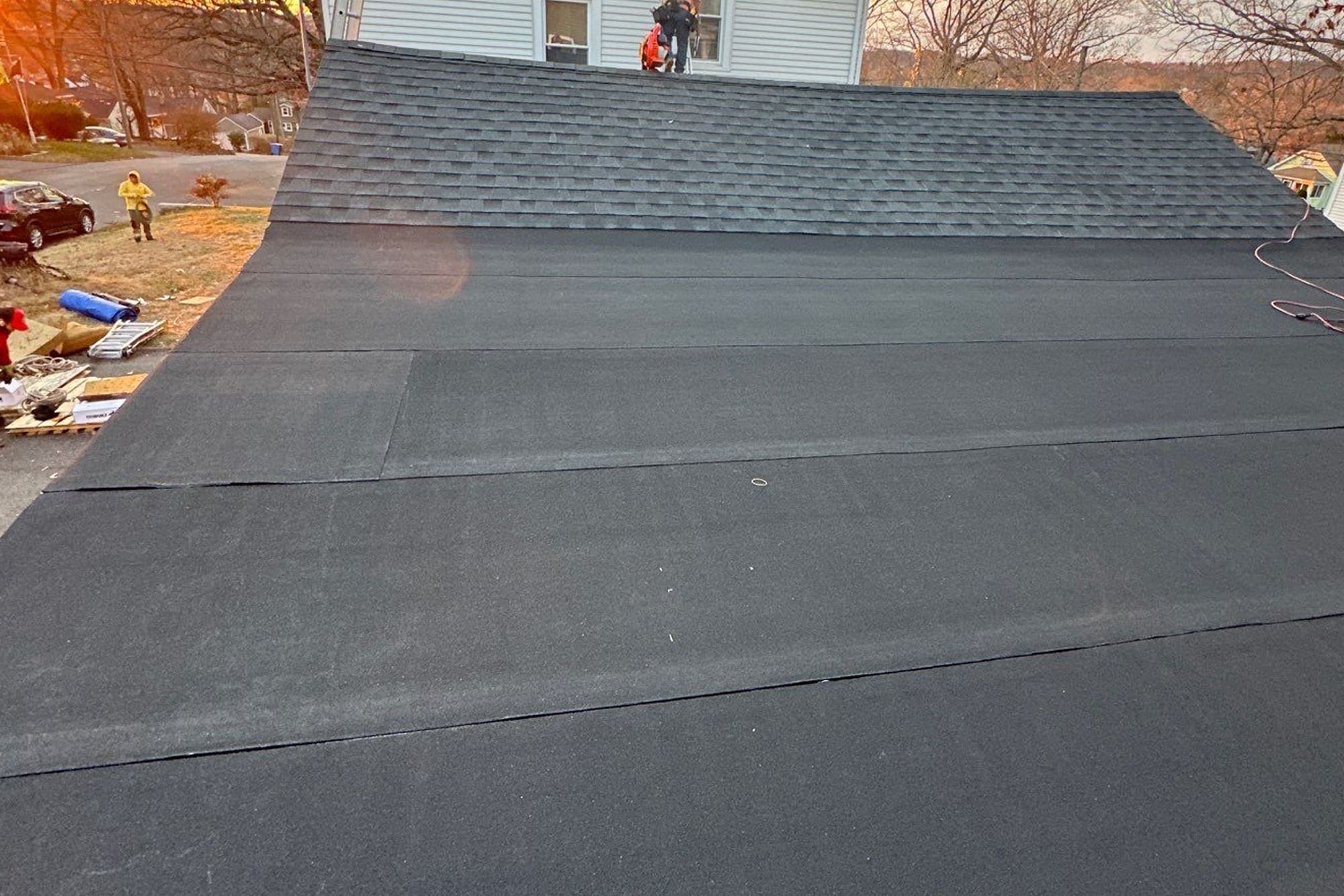 Flat roof installation with asphalt membrane by roofing contractors in Connecticut