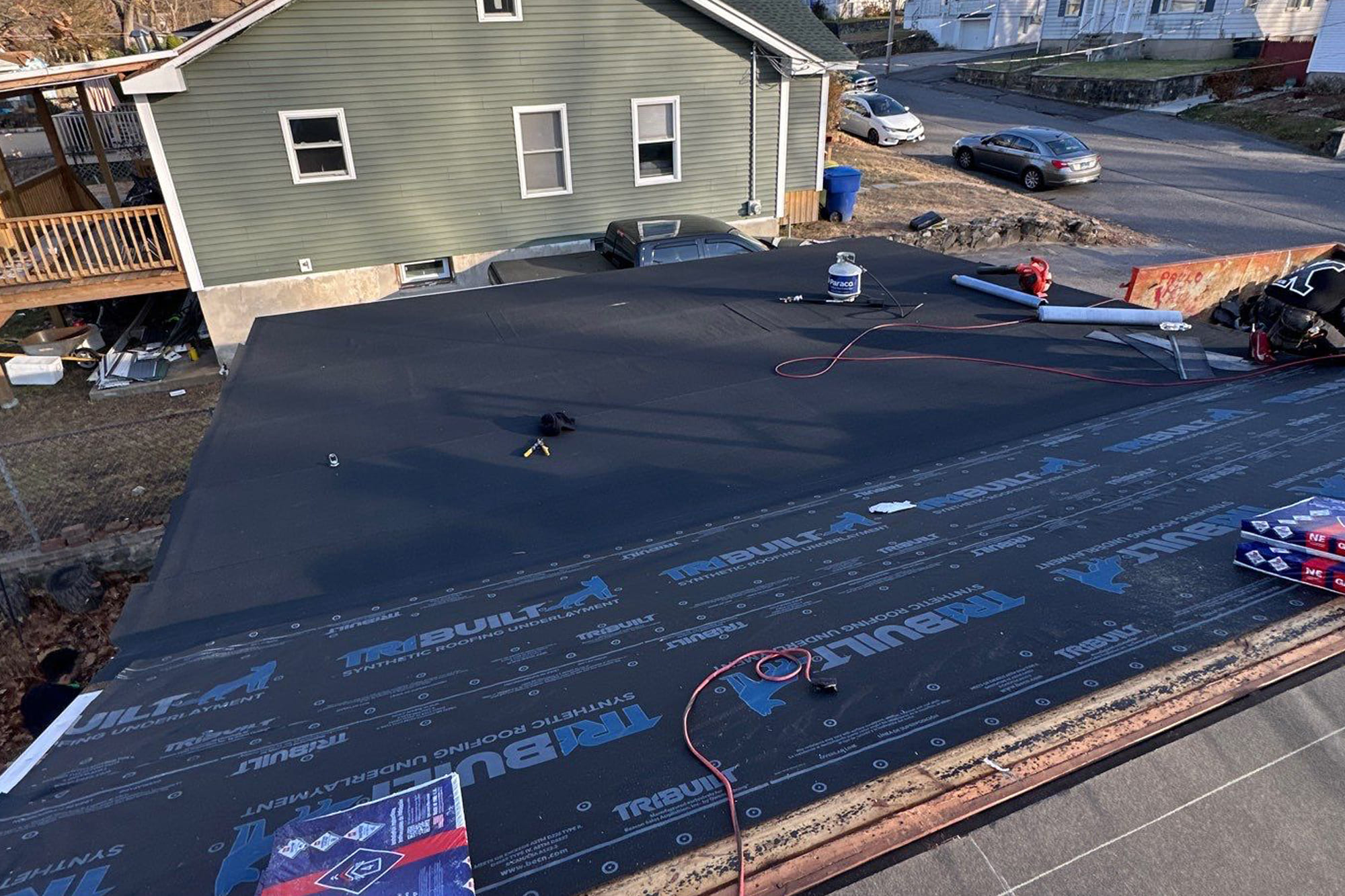 New roof installation in progress with underlayment layer applied in Connecticut