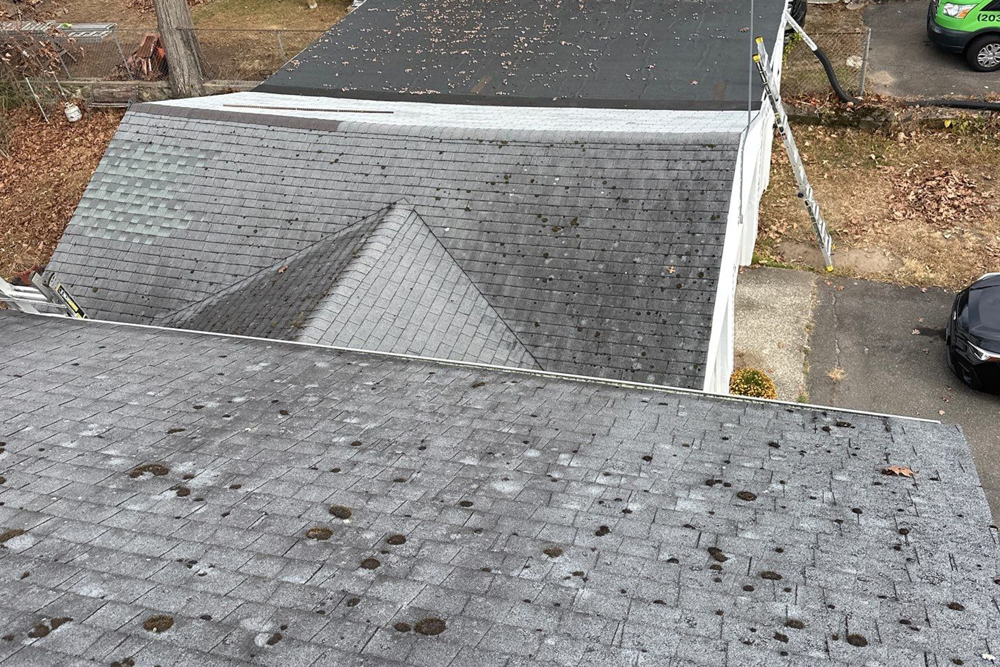 Roof with visible hail damage and dark spots before repair in Connecticut
